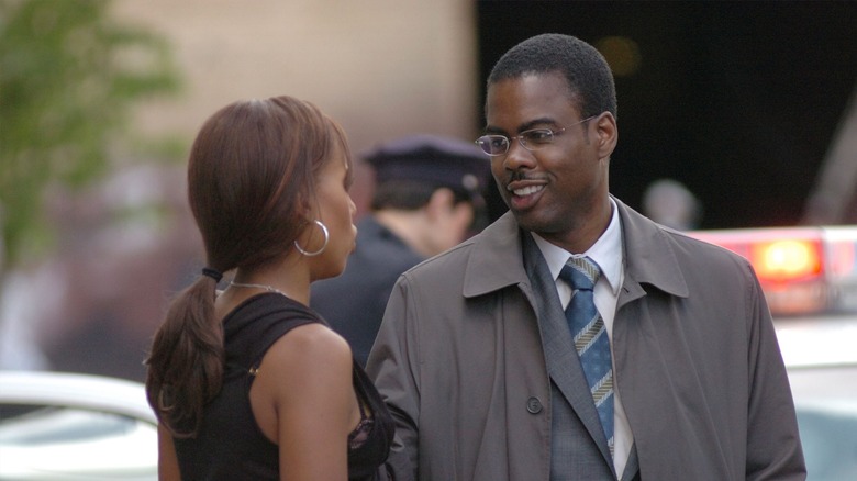 Chris Rock talks to a woman on the street