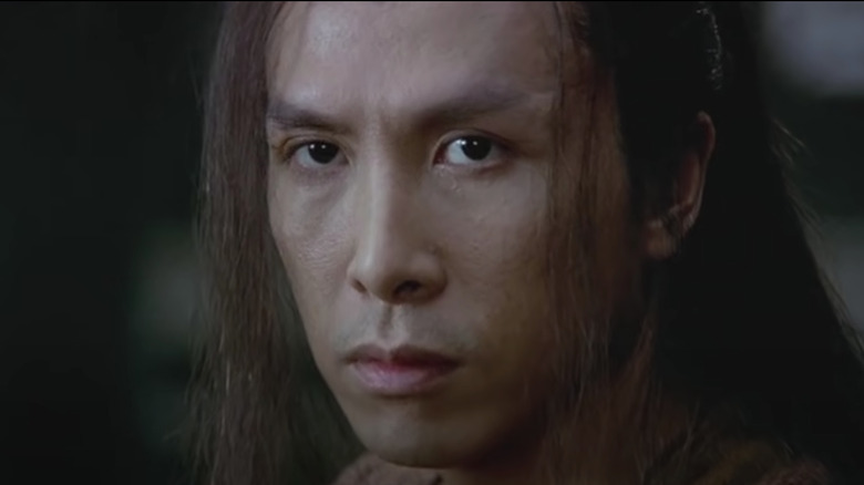 Donnie Yen with long hair glaring