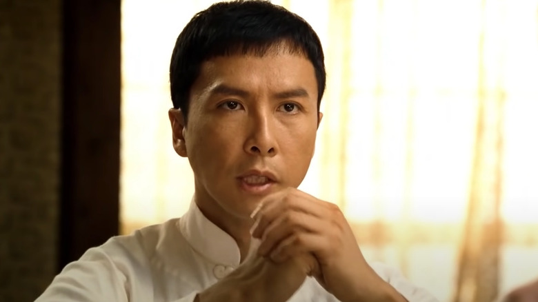 Donnie Yen bowing in a white uniform