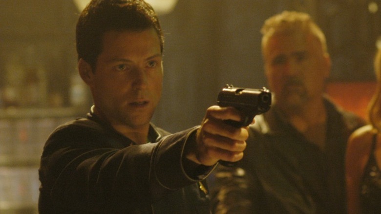 Lee Adama pointing a gun