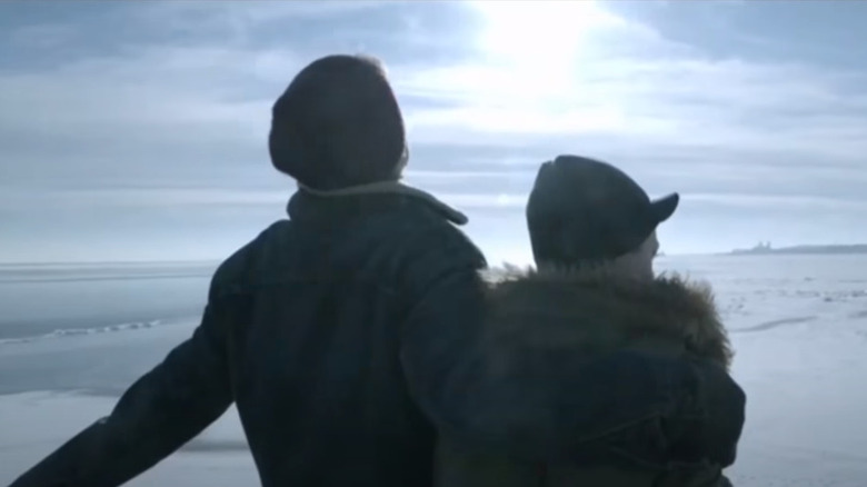 Carl and Frank stand at the edge of the lake