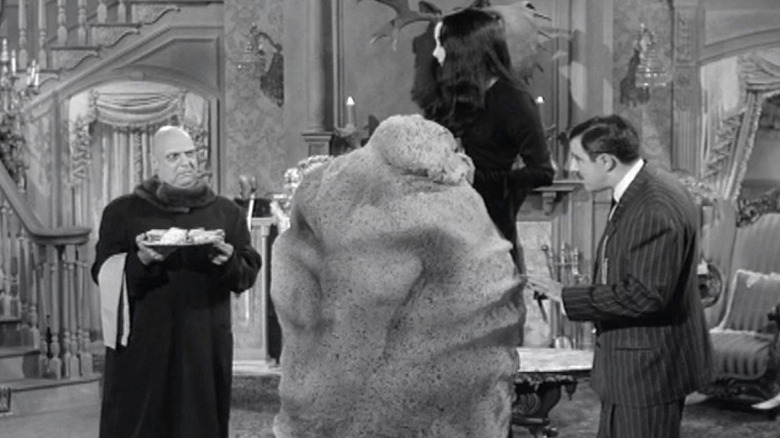 Fester and Gomez admiring Morticia's sculpture