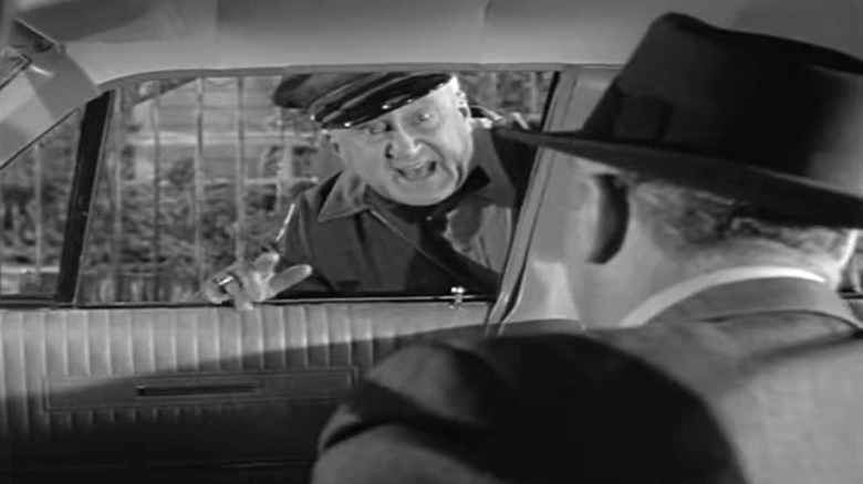 Rolfe Sedan speaking through car window