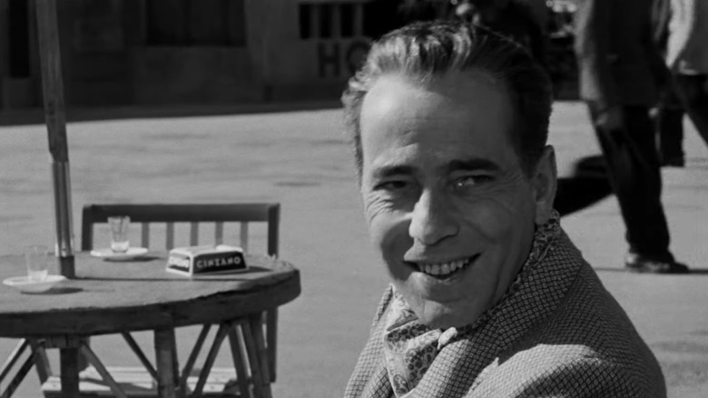 Humphrey Bogart laughing at a cafe