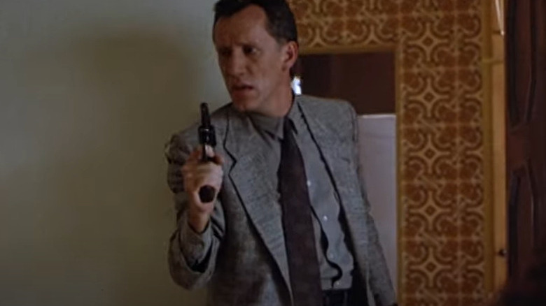 James Woods holding gun