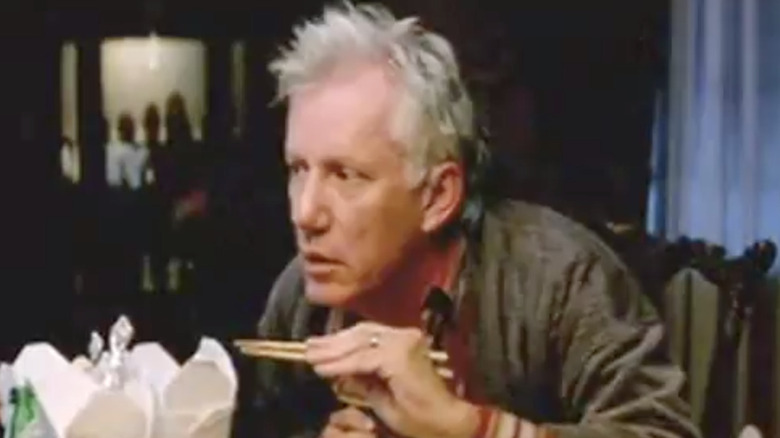 James Woods holding chopsticks