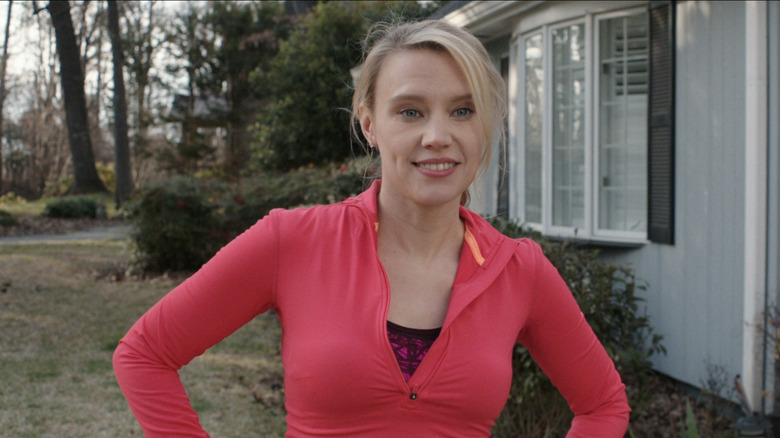 Kate McKinnon stands outside in "Family"