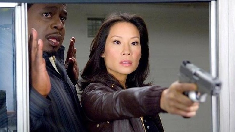 Lucy Liu points a gun