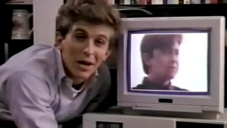 Ferris leans into a computer monitor