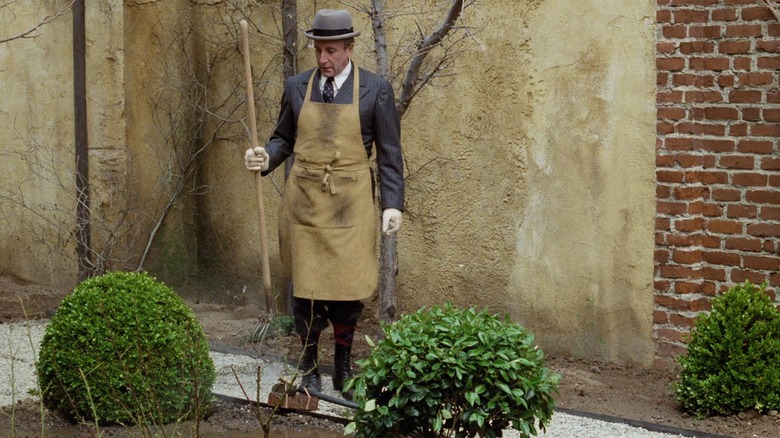 Peter Sellers works in a garden