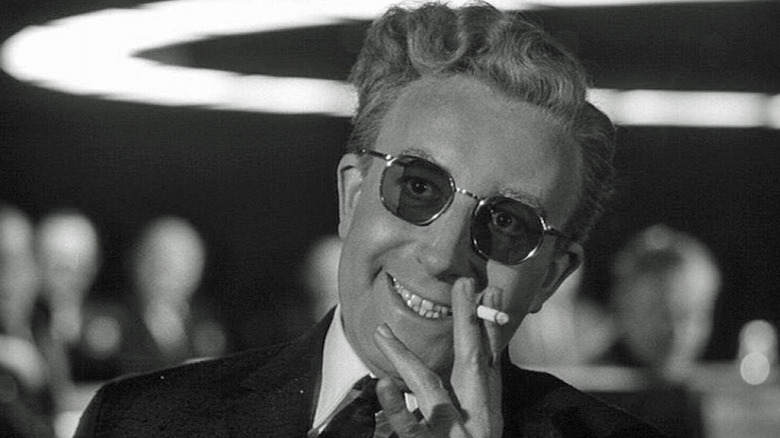 Peter Sellers smokes a cigarette