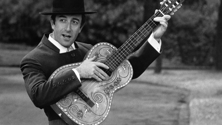 Peter Sellers plays a guitar