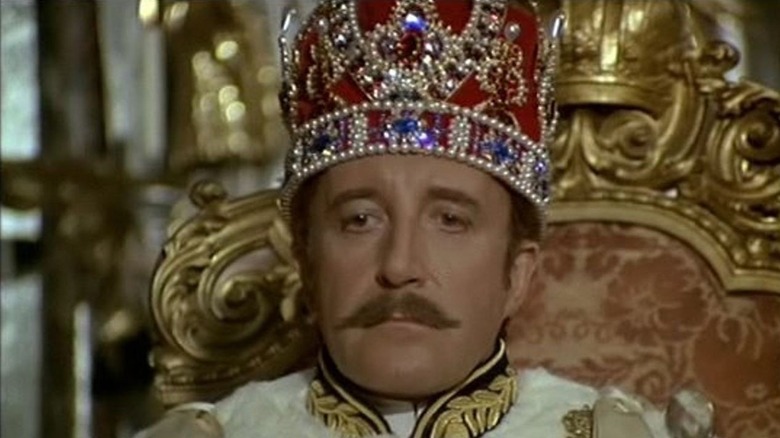 Peter Sellers sits on a throne