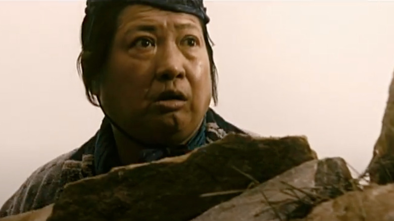 Sammo Hung behind rocks