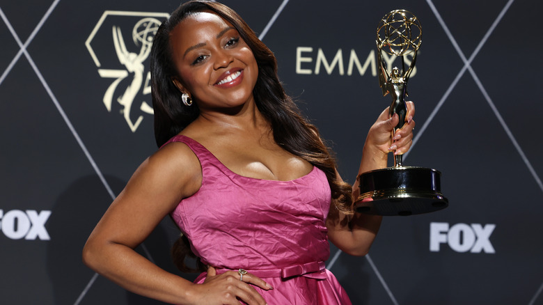 Quinta Brunson holding Emmy trophy