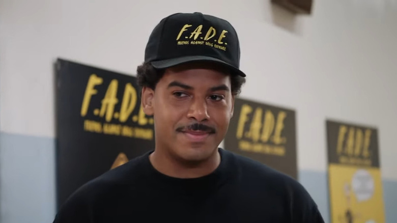 Tariq smiling with FADE posters