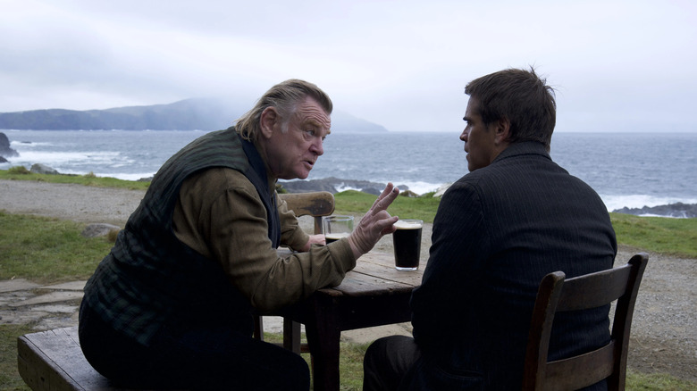 Brendan Gleeson and Colin Farrell at a table in Banshees of Inisherin