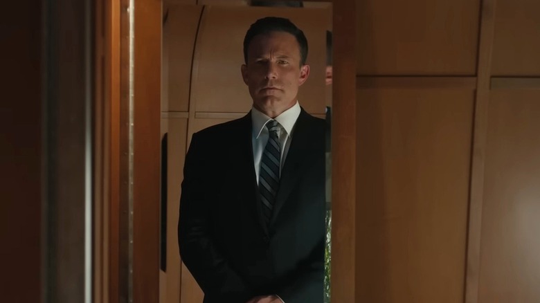 Christian considering his outfit in mirror (2025)