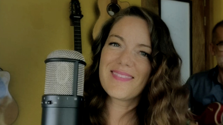 Emilie-Claire Barlow smiling next to a microphone