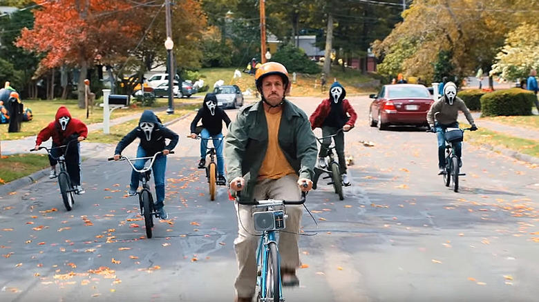 Adam Sandler chased by masked children