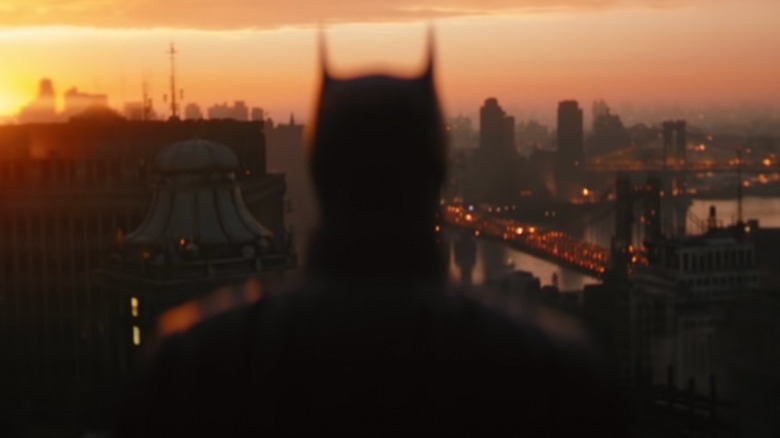 The Batman looks over Gotham City skyline