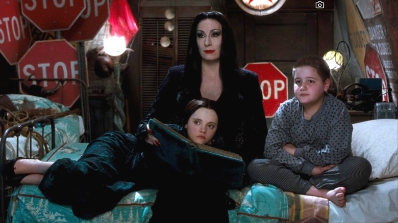 Morticia reads to Wednesday and Pugsley