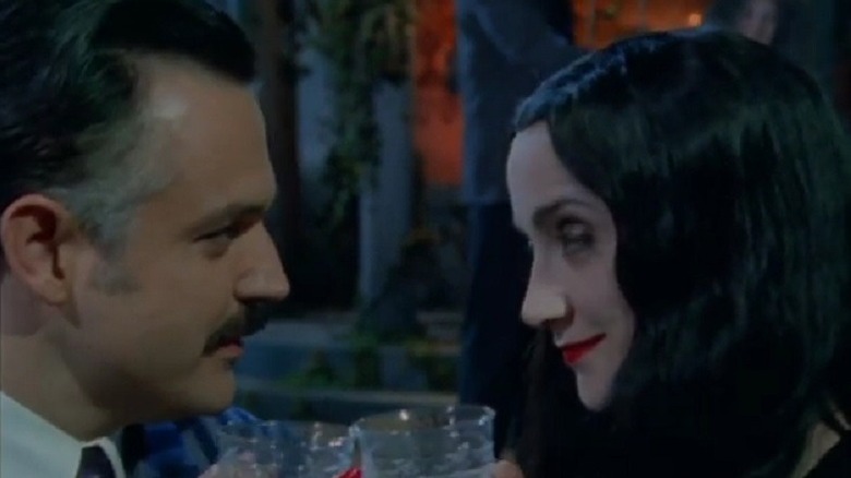 Gomez and Morticia sharing a drink