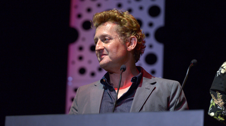 Alex Winter speaking into microphone