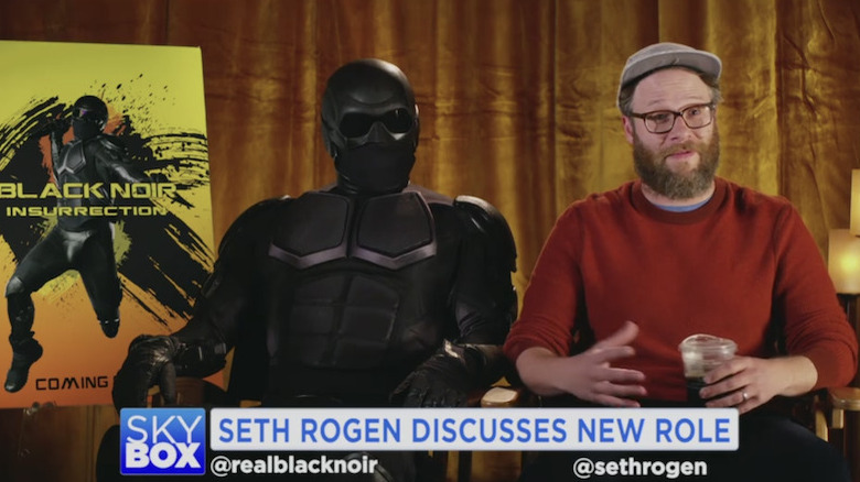 Nathan Mitchell as Black Noir and Seth Rogen as himself in The Boys