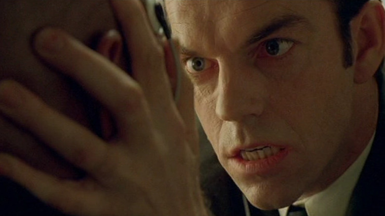 Agent Smith gripping Morpheus' head