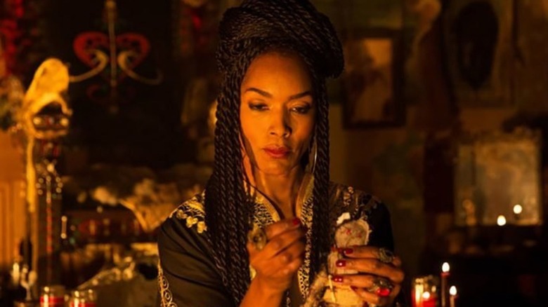 Marie Laveau with a Voodoo doll