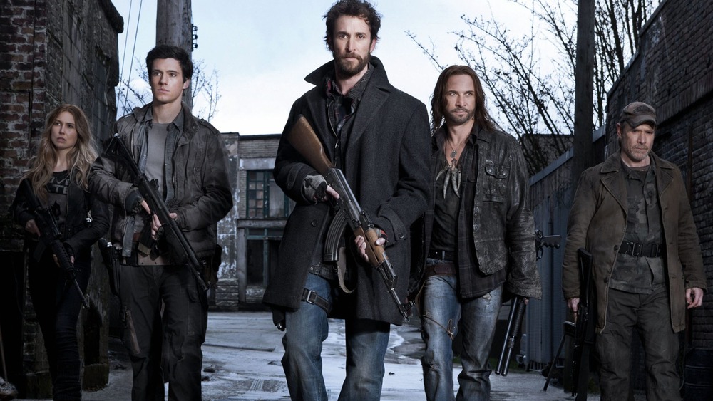 The cast of Falling Skies with weapons