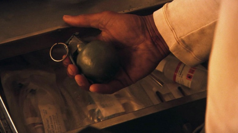 Neville holds a grenade 