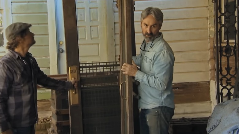 Mike Wolfe holding a door