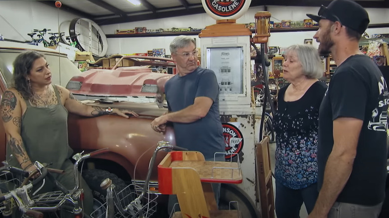 Danielle Colby, Robbie Wolfe, and guests Mickie and Kevin in a warehouse full of car collections