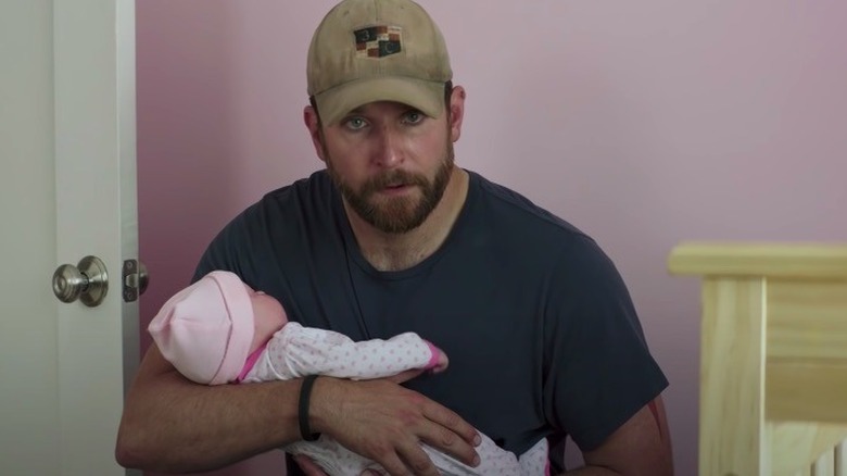 Cooper holds fake baby