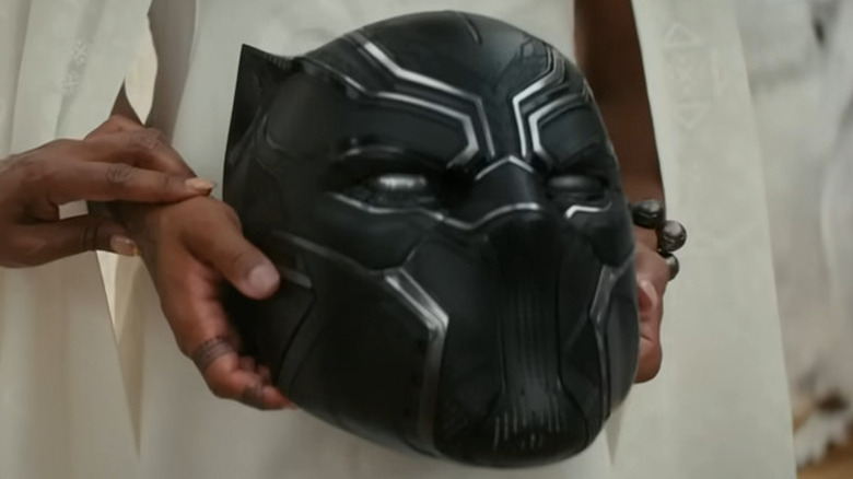 Shuri holding T'Challa's helmet