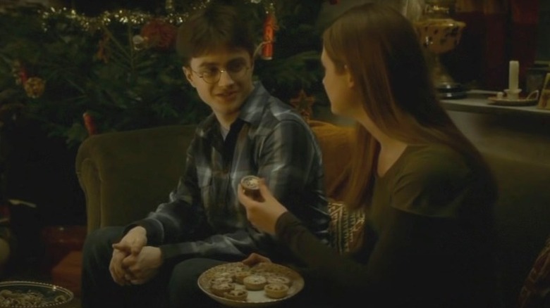 Ginny trying to feed Harry