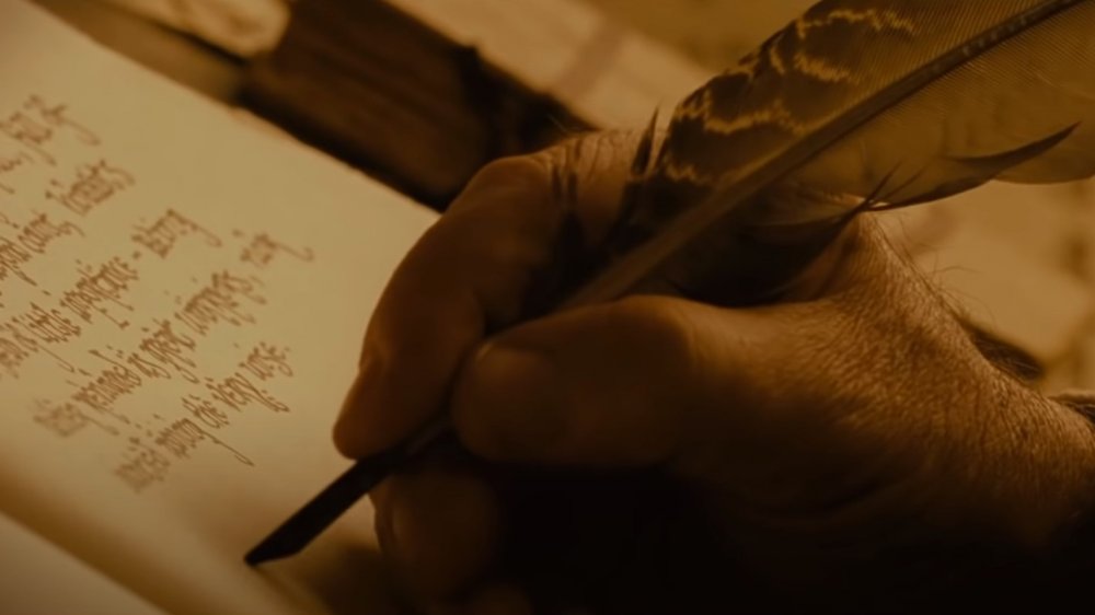 Bilbo writing There and Back Again in The Hobbit