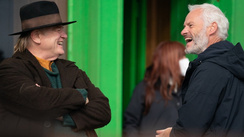 Behind-the-scenes shot of Brendan Gleeson and Martin McDonagh laughing