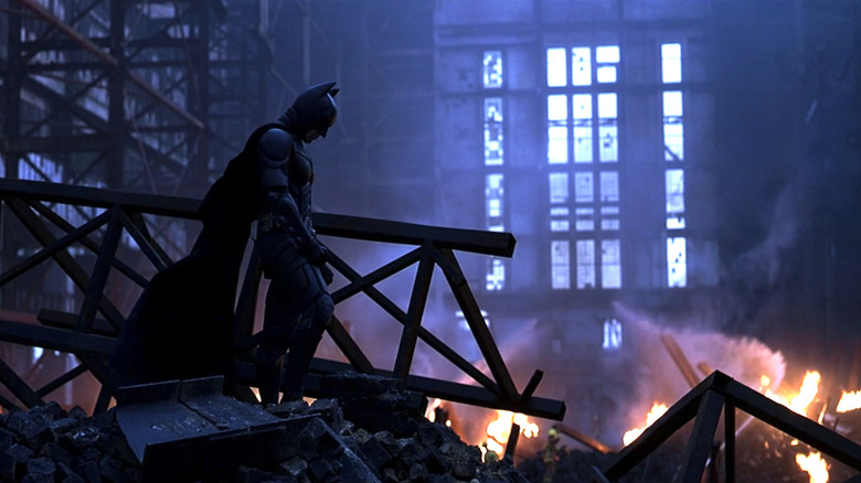 Christian Bale Batman standing on debris