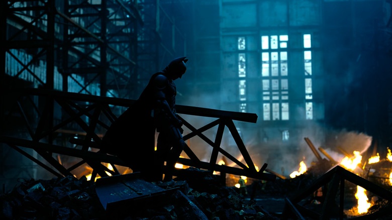 Batman standing in building wreckage