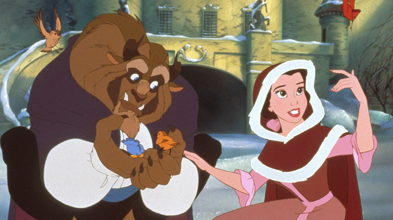 Belle and beast feed birds in the snow