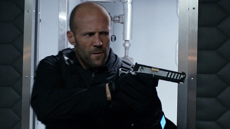 Jason Statham pointing pistol