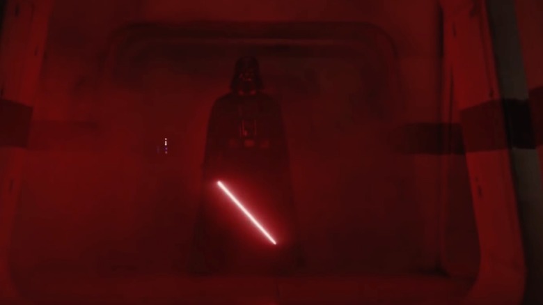 Darth Vader stands with lightsaber drawn