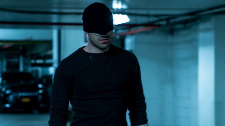 Matt Murdock stands in parking garage