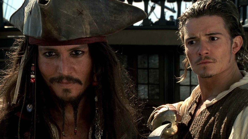 Johnny Depp as Jack Sparrow and Orlando Bloom as Will Turner in Pirates of the Caribbean: The Curse of the Black Pearl