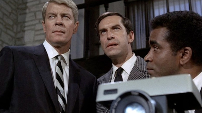 Phelps, Rollins, and Collier watch a film reel