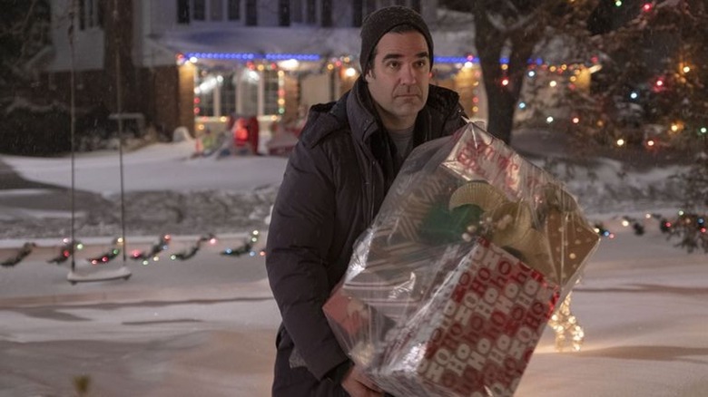 Jeff carrying Christmas packages Home Sweet Home alone