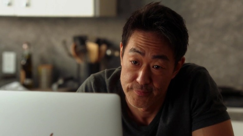 Kenneth Choi looks at laptop